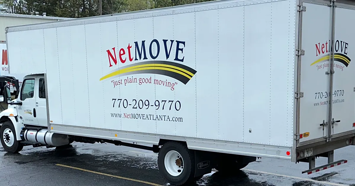Moving truck with NetMOVE branding parked.