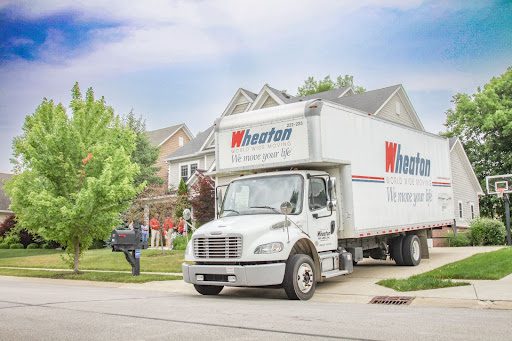 A white Heartland moving truck parked on a suburban street.