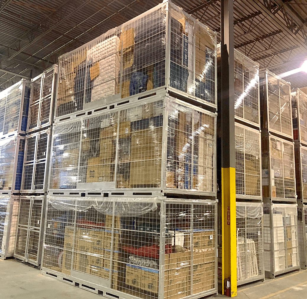 Warehouse storage with stacked metal cages.