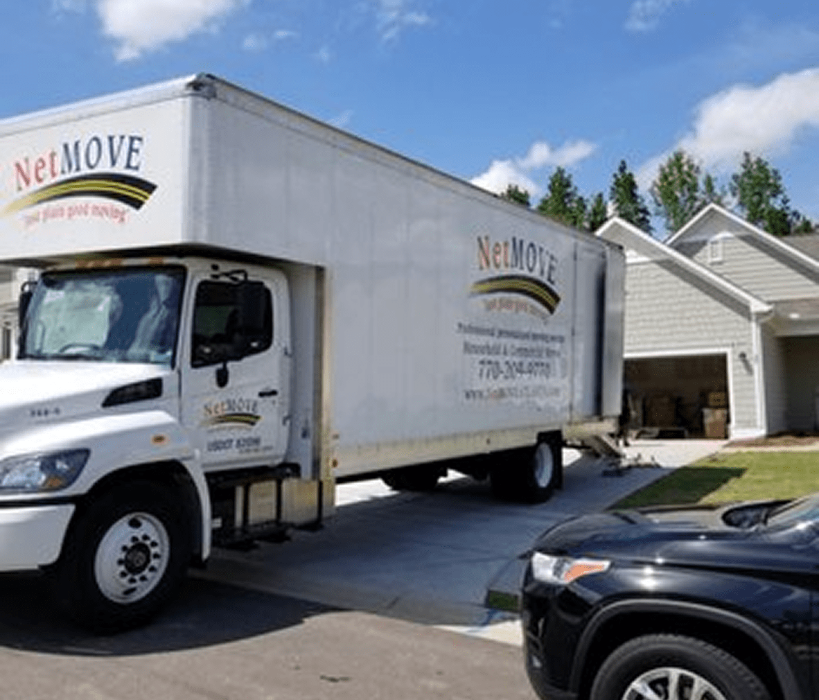 Moving truck parked outside a house.