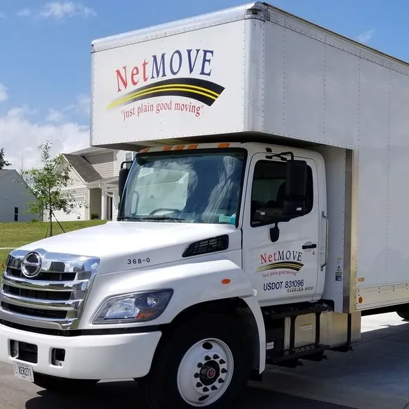 White moving truck parked on residential street.