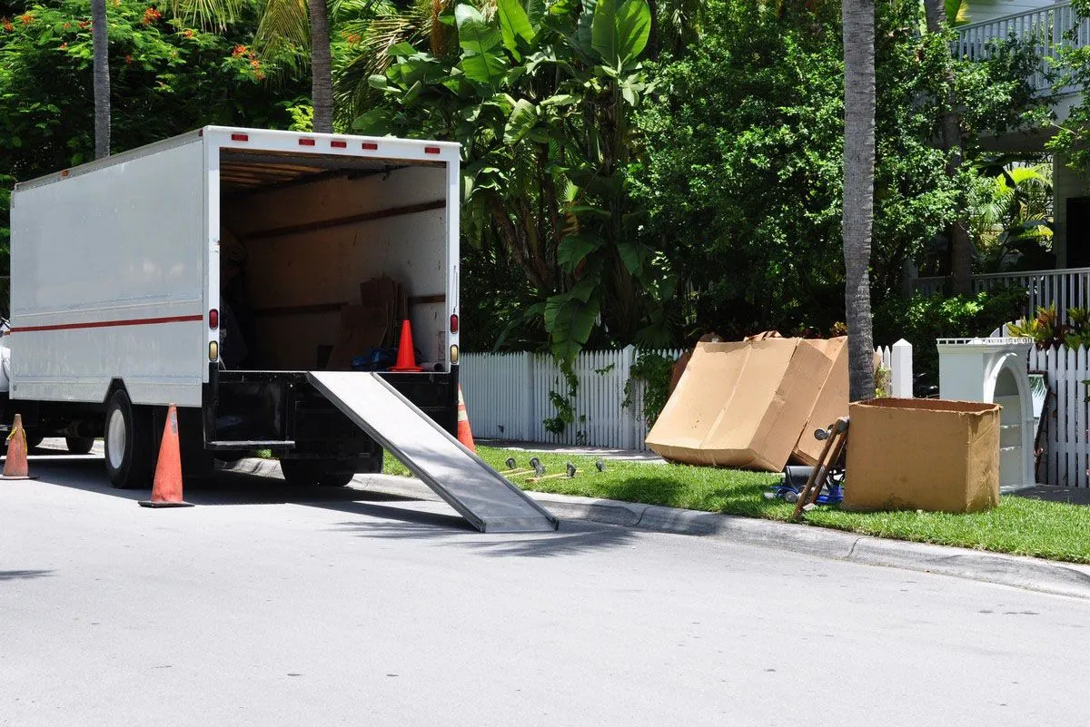 Moving truck with ramp and cardboard boxes.